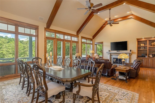 119 Old Still Rd, Sapphire, NC 28774 - dining room featuring a ceiling fan, a high end fireplace, high vaulted ceiling, light wood finished floors, and beam ceiling