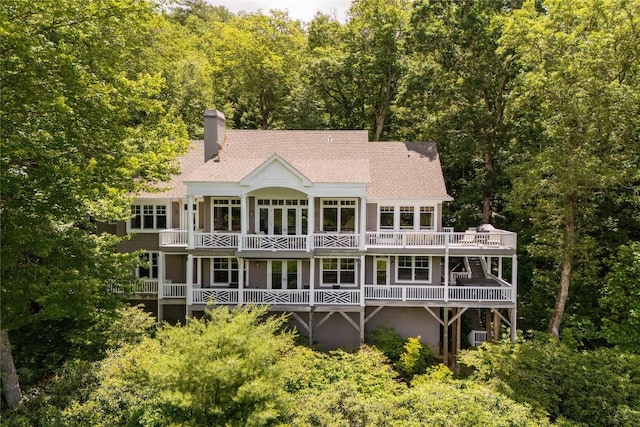 119 Old Still Rd, Sapphire, NC 28774 - rear view of house with roof with shingles, a chimney, a view of trees, and a balcony