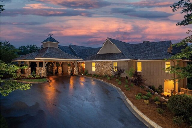119 Old Still Rd, Sapphire, NC 28774 - view of front of house featuring a gazebo, asphalt driveway, stone siding, and a chimney