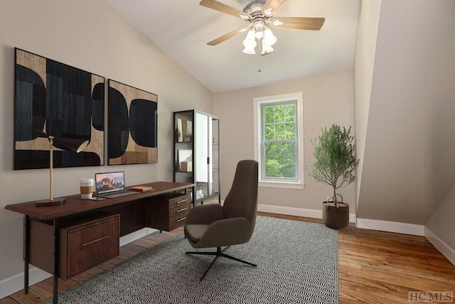 home office with ceiling fan, lofted ceiling, and light hardwood / wood-style floors