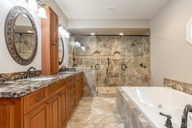 bathroom with vanity and separate shower and tub