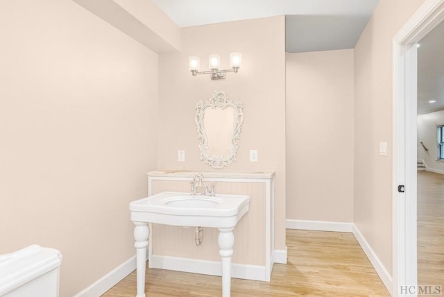 bathroom with hardwood / wood-style floors and toilet