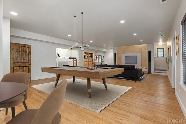 playroom with a baseboard heating unit, pool table, and light wood-type flooring