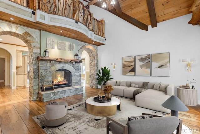 living room featuring wood ceiling, high vaulted ceiling, beam ceiling, and hardwood / wood-style floors