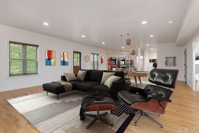 living room featuring light hardwood / wood-style flooring and billiards