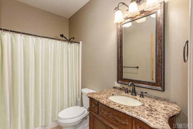 bathroom with vanity, toilet, and walk in shower