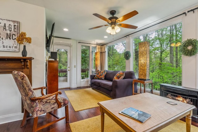 sunroom / solarium featuring wood finished floors, recessed lighting, baseboards, and french doors