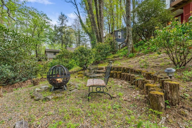 view of yard with a fire pit