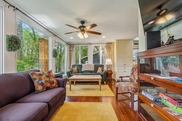 living room with ceiling fan and wood finished floors