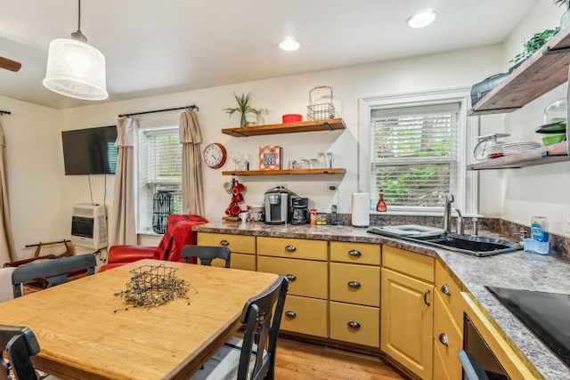 kitchen featuring open shelves, a sink, plenty of natural light, heating unit, and recessed lighting