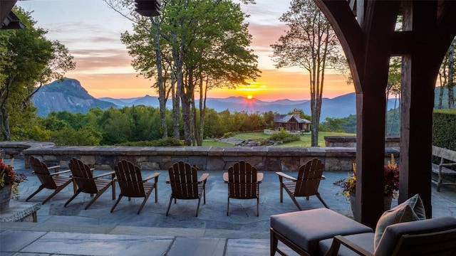 patio terrace at dusk with a gazebo and a mountain view