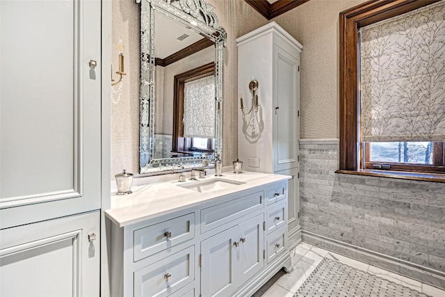 bathroom featuring plenty of natural light, vanity, and ornamental molding