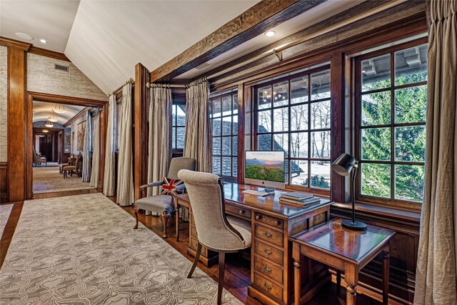 home office with visible vents, wood finished floors, and lofted ceiling
