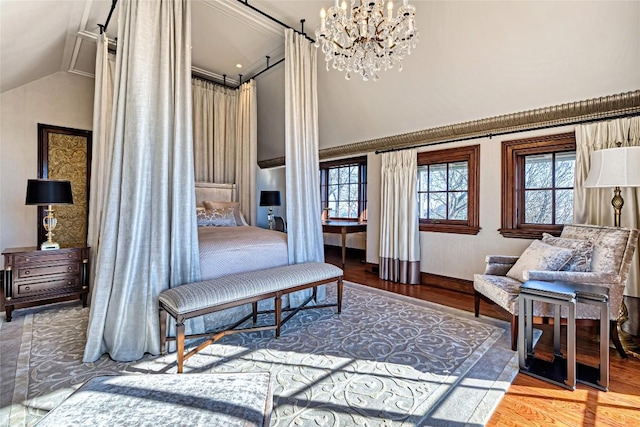 bedroom with wood finished floors, multiple windows, a chandelier, and high vaulted ceiling