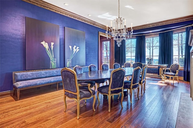 dining area featuring an inviting chandelier, recessed lighting, wood-type flooring, and crown molding