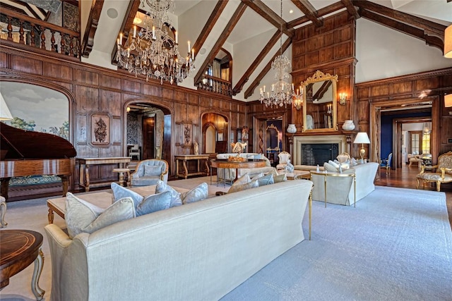 living room featuring wood walls, beam ceiling, high vaulted ceiling, arched walkways, and a notable chandelier