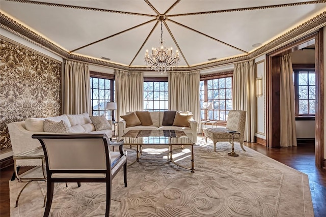 living room with a notable chandelier, plenty of natural light, dark wood finished floors, and vaulted ceiling