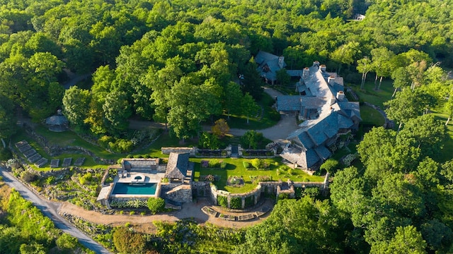 drone / aerial view with a wooded view