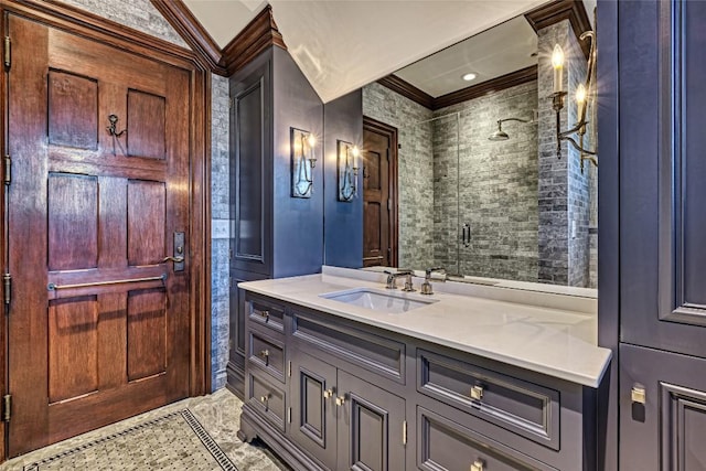 bathroom with crown molding, vanity, and a shower stall