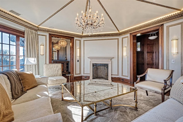 living area with a chandelier, visible vents, and a fireplace