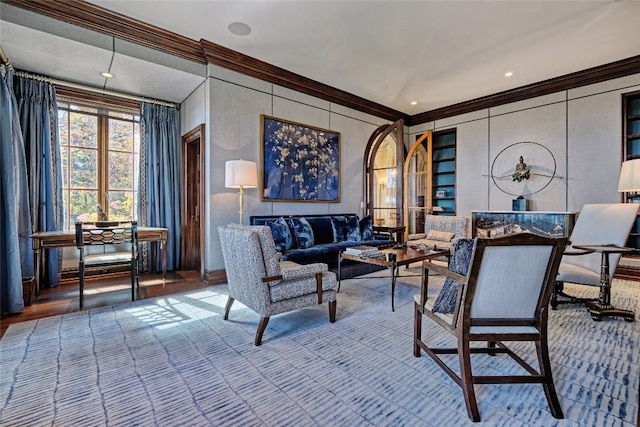 living area with crown molding and baseboards