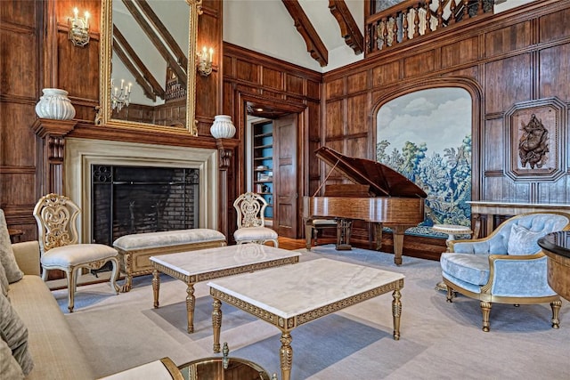 living area with wooden walls, built in features, a high ceiling, and carpet flooring