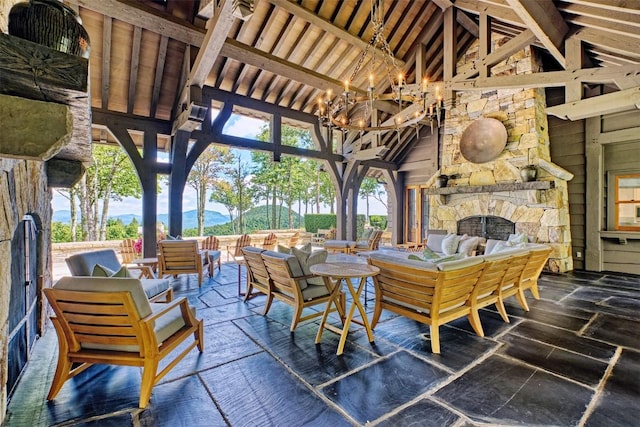 view of patio / terrace with an outdoor living space with a fireplace and a gazebo