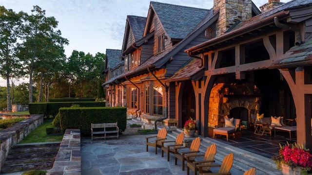 view of patio featuring an outdoor stone fireplace