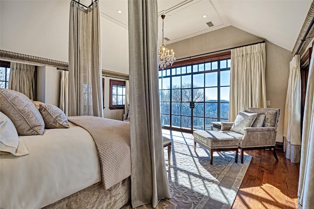 bedroom featuring an inviting chandelier, high vaulted ceiling, wood finished floors, and visible vents
