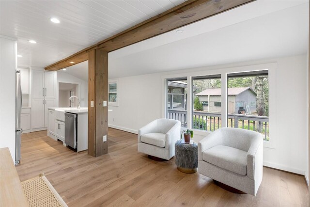 sitting room featuring light wood-style floors, lofted ceiling with beams, baseboards, and recessed lighting