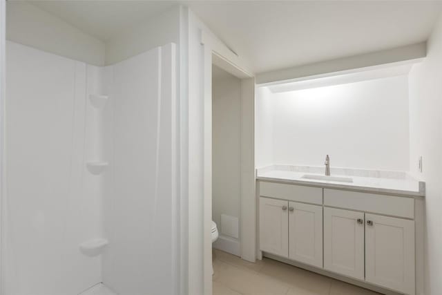 bathroom with toilet, walk in shower, tile patterned floors, and vanity