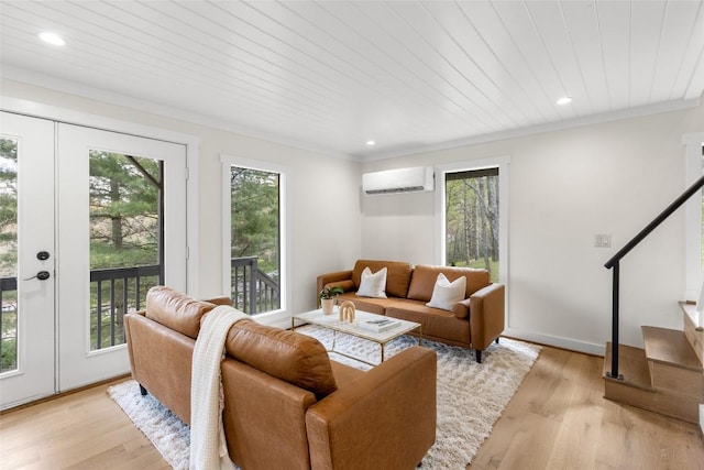 living area featuring a wall mounted AC, french doors, and a healthy amount of sunlight