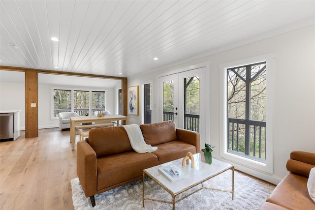 living room with a wealth of natural light, wood ceiling, french doors, and light wood-style floors