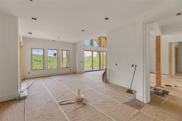 148 E Ridge Rd, Cashiers, NC 28717 - unfurnished living room featuring plenty of natural light and baseboards
