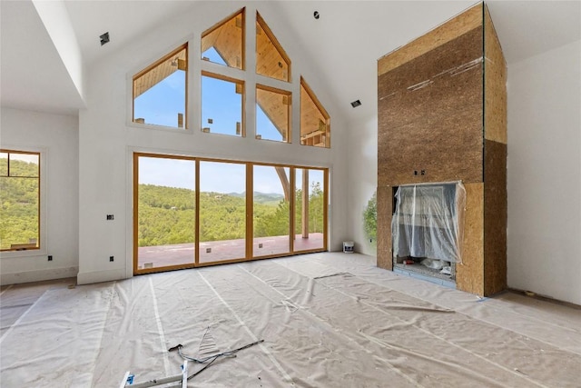 148 E Ridge Rd, Cashiers, NC 28717 - unfurnished living room with high vaulted ceiling and baseboards