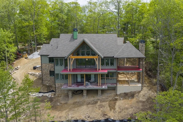 148 E Ridge Rd, Cashiers, NC 28717 - rear view of property with a chimney, a shingled roof, and a sunroom