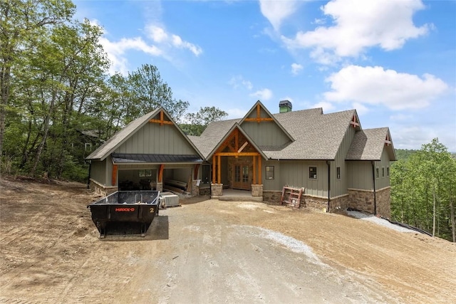 148 E Ridge Rd, Cashiers, NC 28717 - view of front facade with dirt driveway, roof with shingles, a chimney, and board and batten siding