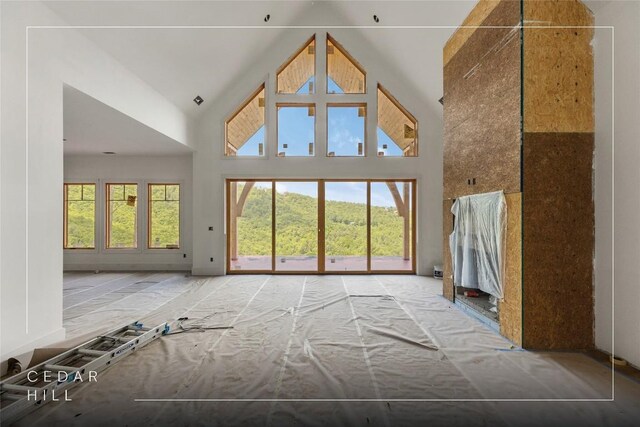 148 E Ridge Rd, Cashiers, NC 28717 - unfurnished living room with high vaulted ceiling and plenty of natural light