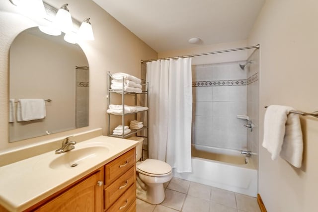 full bath featuring toilet, vanity, shower / bath combo with shower curtain, and tile patterned floors