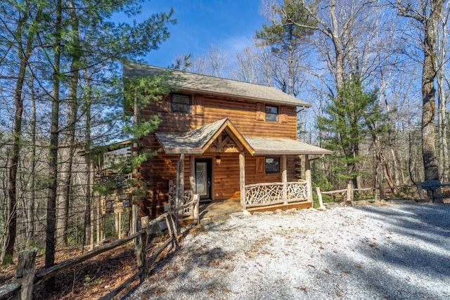 log-style house featuring a porch