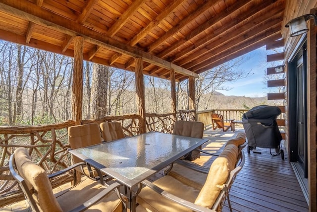 sunroom / solarium with lofted ceiling with beams and wooden ceiling