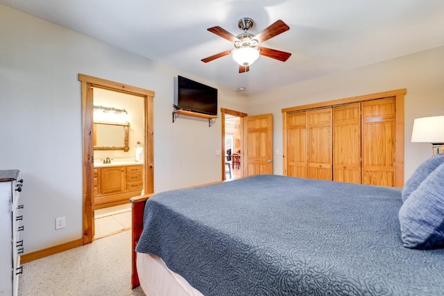 bedroom featuring light carpet, baseboards, connected bathroom, ceiling fan, and a sink