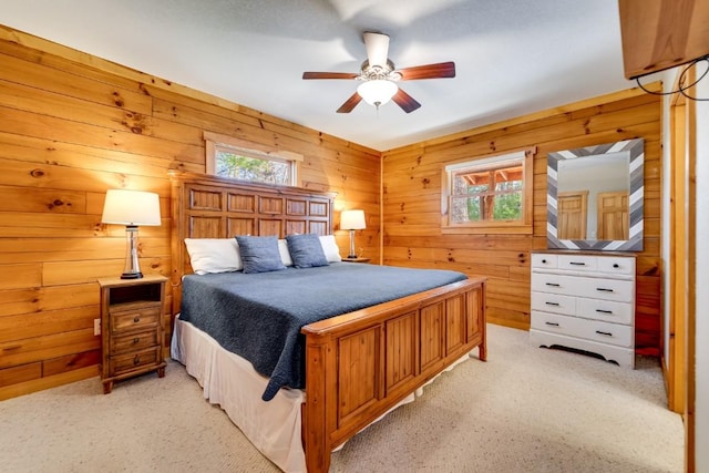 bedroom with wooden walls and light colored carpet