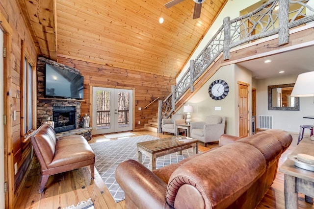 living room with visible vents, wooden ceiling, stairway, french doors, and a fireplace