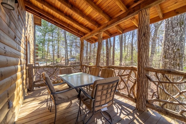 sunroom / solarium featuring vaulted ceiling with beams and wooden ceiling