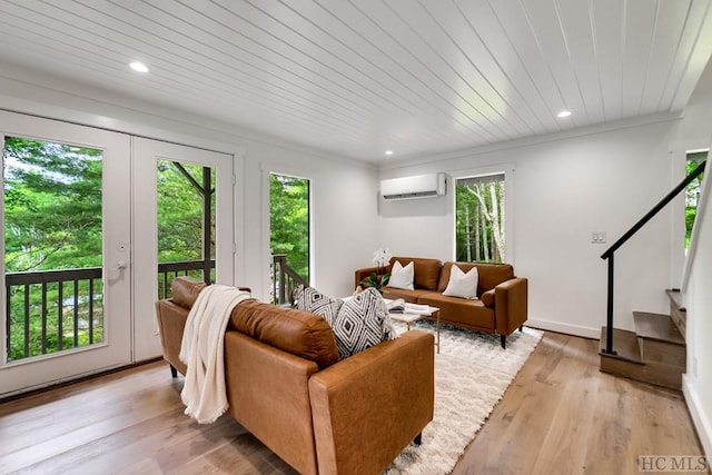 living room with french doors, light hardwood / wood-style floors, a wall unit AC, and wooden ceiling