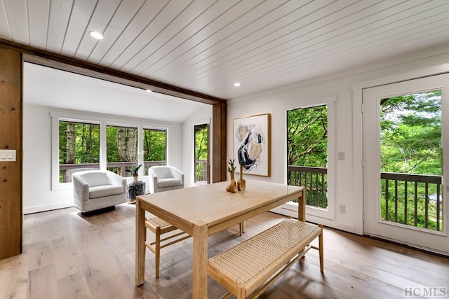 dining room with wood ceiling, light hardwood / wood-style flooring, and vaulted ceiling with beams