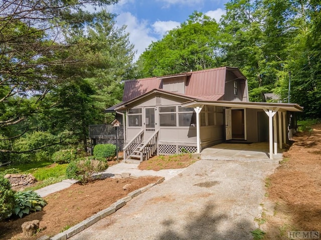 view of front of house with a sunroom and a carport