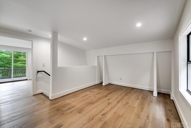 basement with light hardwood / wood-style floors