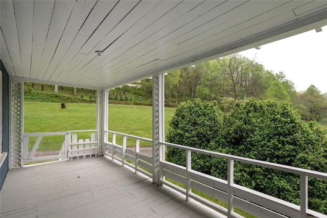 wooden terrace featuring a yard